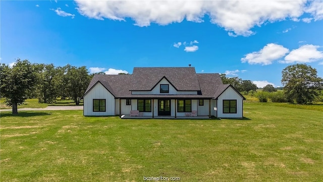 rear view of house with a lawn