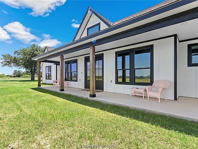 rear view of property featuring a yard