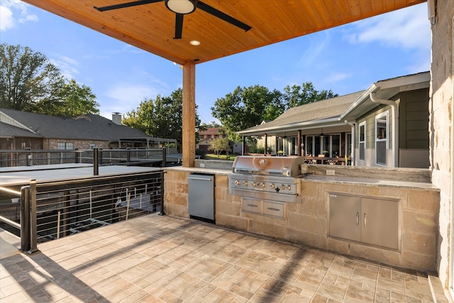 view of patio / terrace with ceiling fan, grilling area, and exterior kitchen