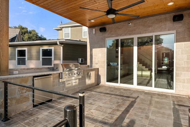 view of patio with exterior kitchen, ceiling fan, and grilling area