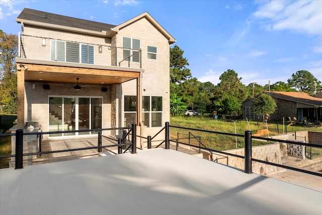 rear view of property featuring ceiling fan and a patio