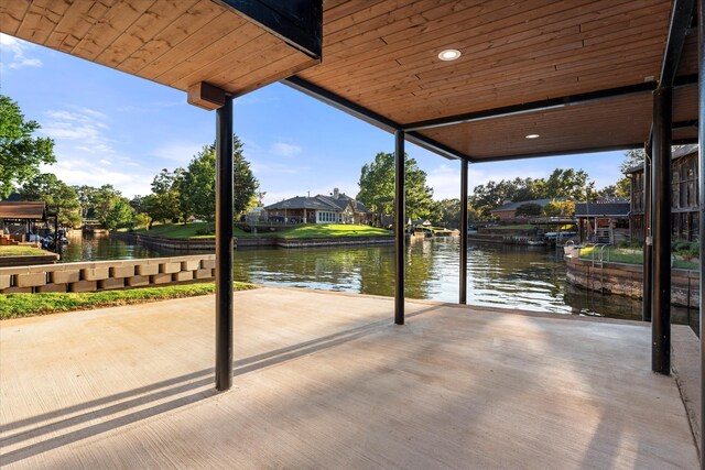 view of patio / terrace with a water view and a dock