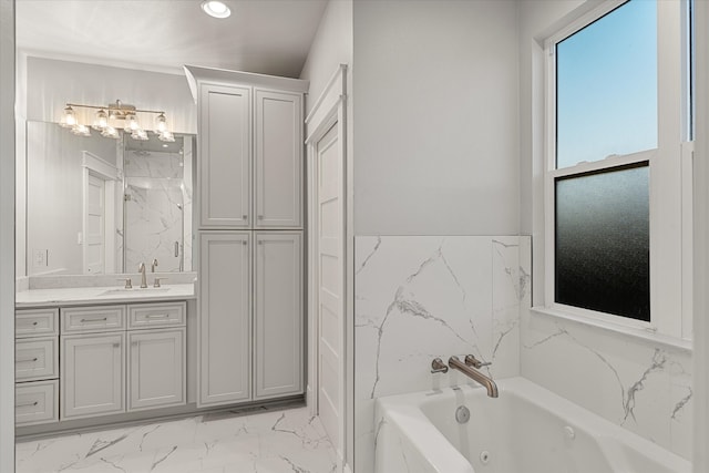 bathroom featuring vanity and a tub