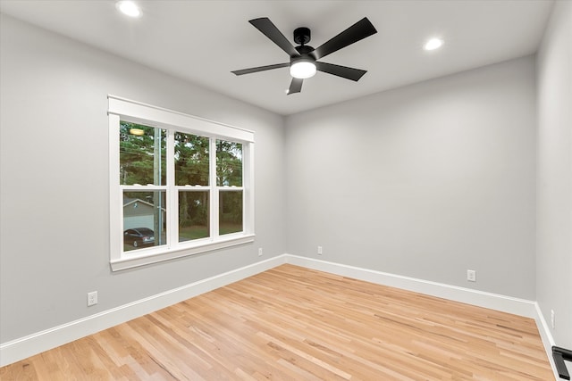 spare room featuring ceiling fan and hardwood / wood-style floors