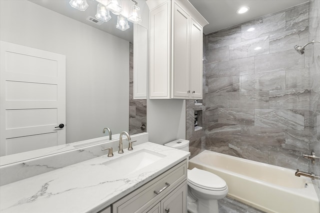 full bathroom featuring vanity, toilet, and tiled shower / bath