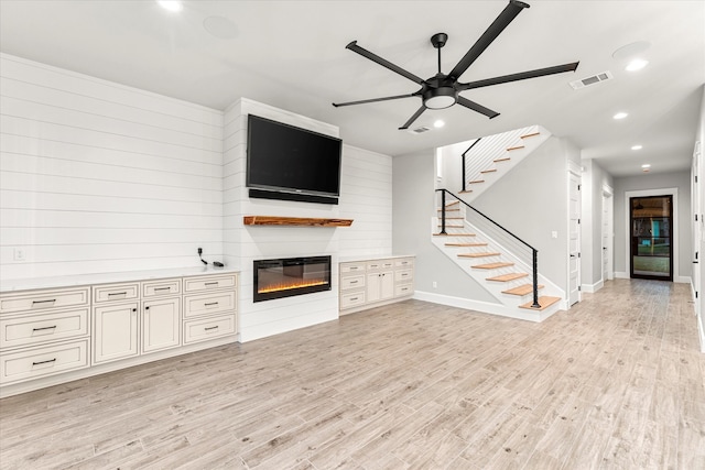 unfurnished living room with light hardwood / wood-style floors and ceiling fan