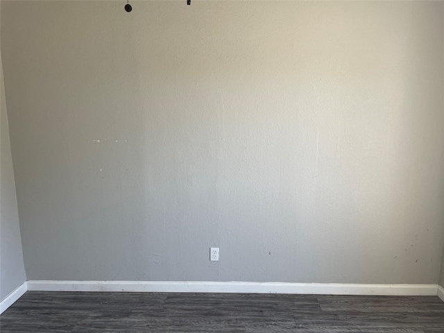 empty room with dark hardwood / wood-style flooring