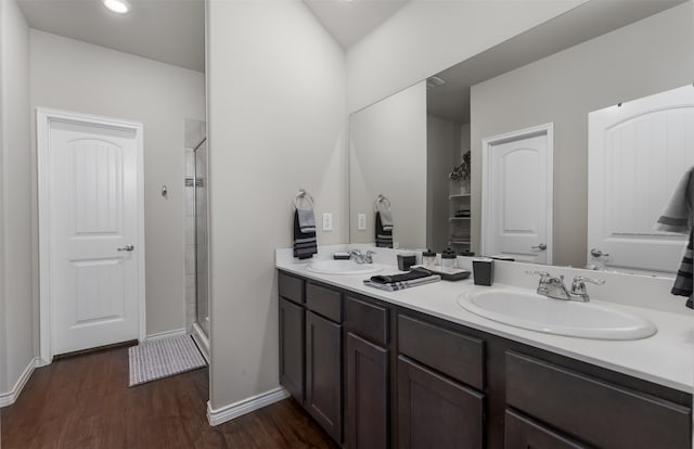 bathroom featuring vanity, a shower with shower door, and hardwood / wood-style flooring