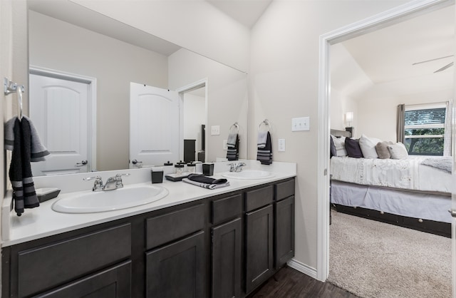 bathroom featuring ceiling fan, vanity, vaulted ceiling, and hardwood / wood-style flooring