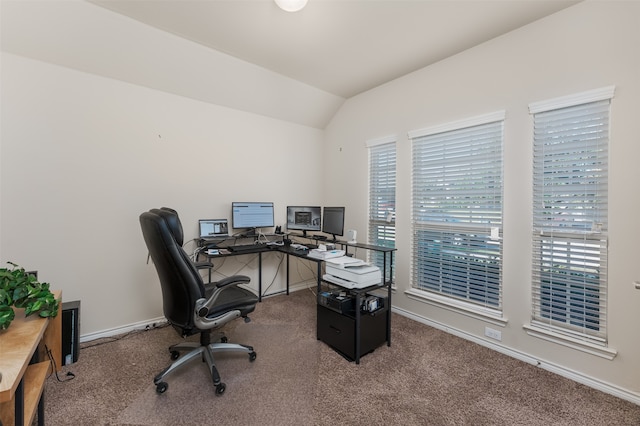 carpeted home office with lofted ceiling