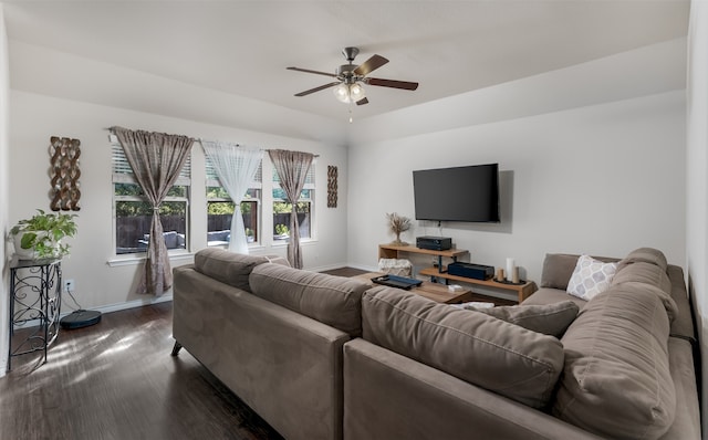 living room featuring dark wood-type flooring and ceiling fan