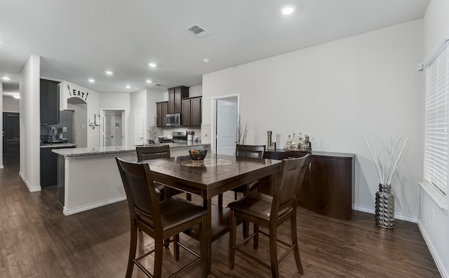 dining area featuring dark hardwood / wood-style floors