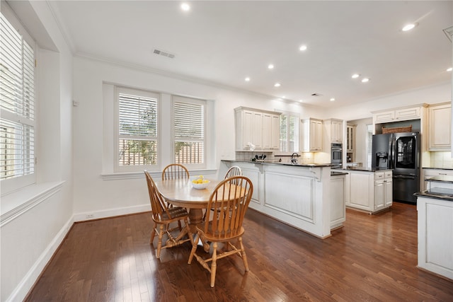 kitchen featuring black refrigerator with ice dispenser, stainless steel oven, decorative backsplash, dark hardwood / wood-style floors, and ornamental molding