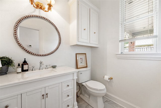 bathroom with tile patterned flooring, vanity, and toilet