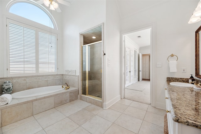 bathroom with tile patterned flooring, crown molding, separate shower and tub, and vanity