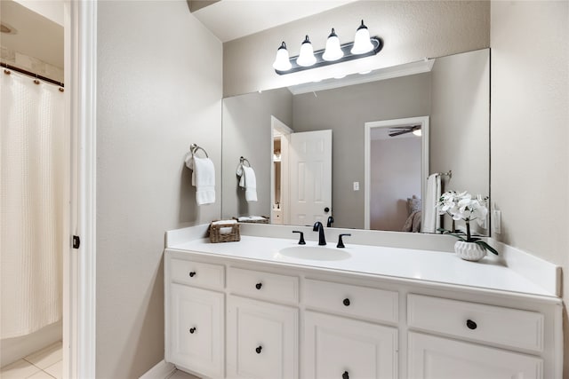 bathroom with curtained shower, tile patterned floors, and vanity