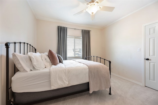 bedroom with ceiling fan, light carpet, and ornamental molding