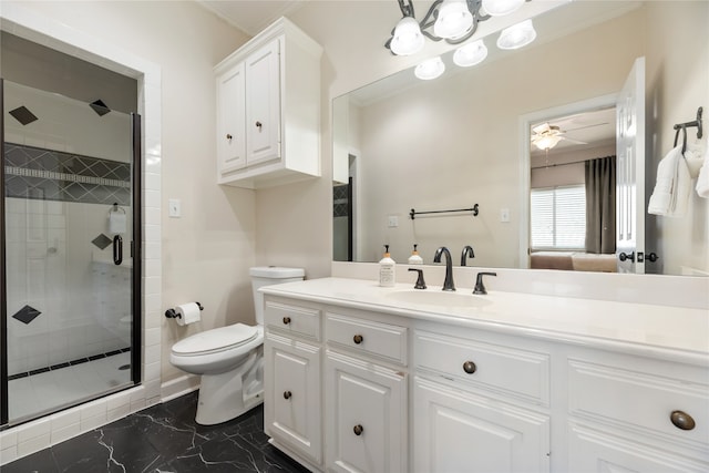 bathroom featuring ceiling fan, vanity, a shower with door, and toilet