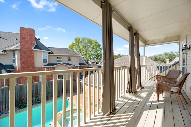 deck with a fenced in pool