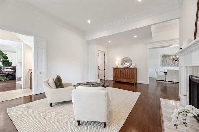 living room with a notable chandelier, crown molding, and dark hardwood / wood-style flooring