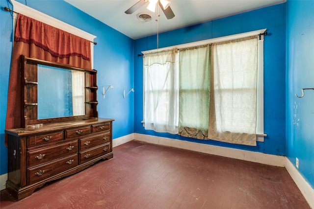 unfurnished bedroom with dark wood-type flooring and ceiling fan