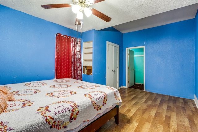 bedroom featuring wood-type flooring, a closet, a textured ceiling, and ceiling fan