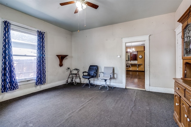 office featuring ceiling fan with notable chandelier and dark colored carpet