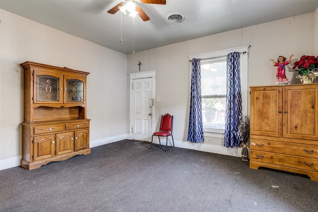 misc room featuring dark carpet and ceiling fan