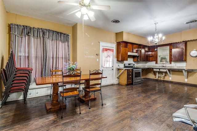 kitchen featuring exhaust hood, dark hardwood / wood-style floors, ceiling fan with notable chandelier, kitchen peninsula, and stainless steel range with gas cooktop