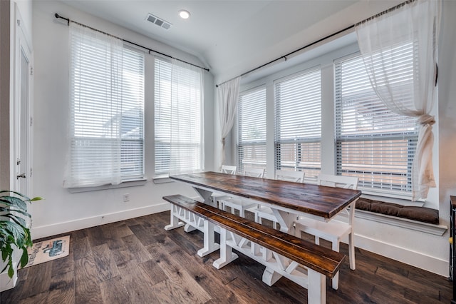 dining area with lofted ceiling and dark wood-type flooring