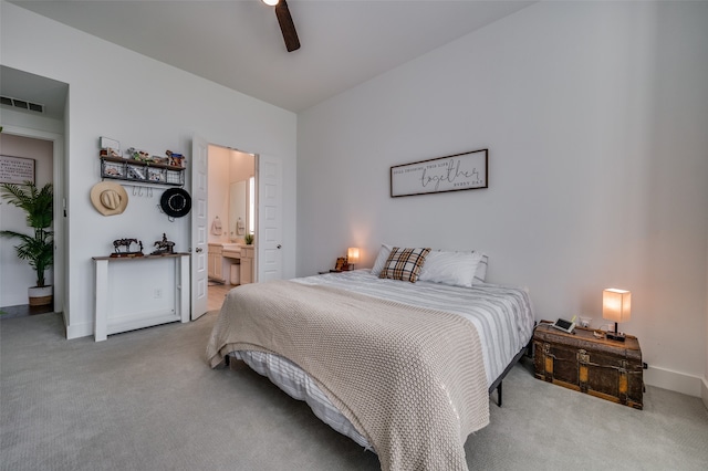 carpeted bedroom featuring ensuite bathroom and ceiling fan