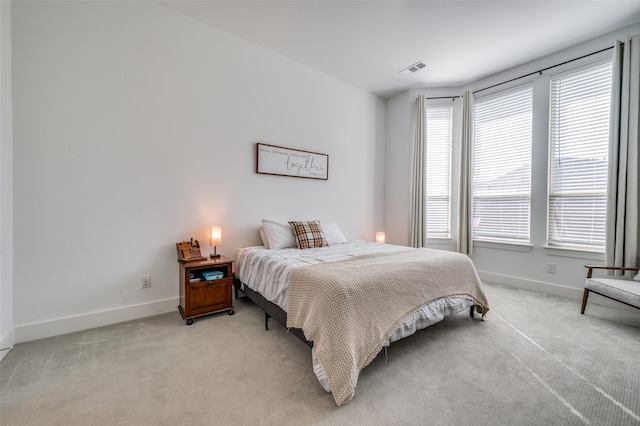 bedroom featuring light colored carpet