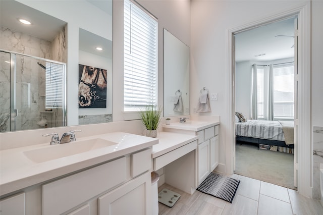 bathroom featuring vanity and a shower with shower door