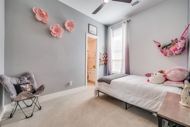 carpeted bedroom with ceiling fan and connected bathroom