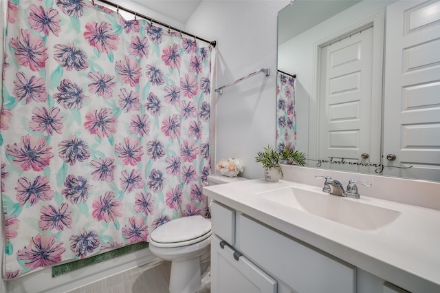 bathroom featuring toilet, vanity, and a shower with shower curtain