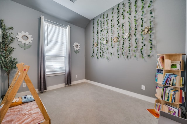 recreation room featuring carpet floors and vaulted ceiling