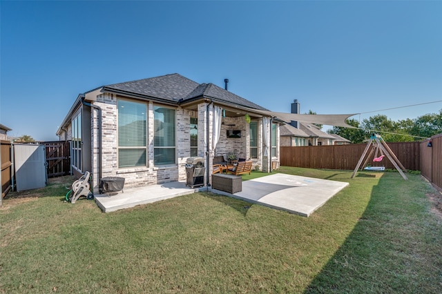 rear view of property featuring an outdoor hangout area, a lawn, and a patio area