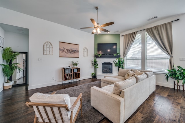 living room with ceiling fan and dark hardwood / wood-style floors