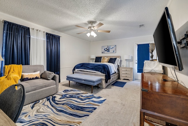 carpeted bedroom featuring ceiling fan, crown molding, and a textured ceiling