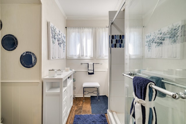 bathroom with ornamental molding, hardwood / wood-style floors, a shower with door, and a wealth of natural light