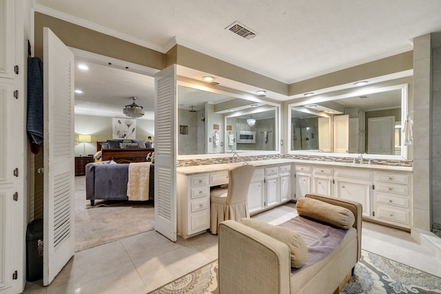 bathroom with walk in shower, vanity, ornamental molding, and tile patterned floors