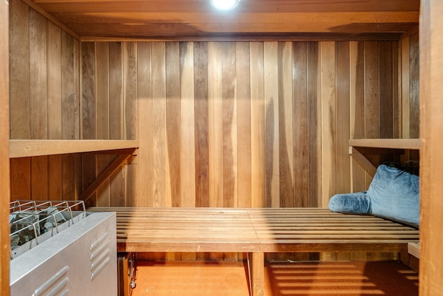 view of sauna / steam room with hardwood / wood-style flooring and wooden walls