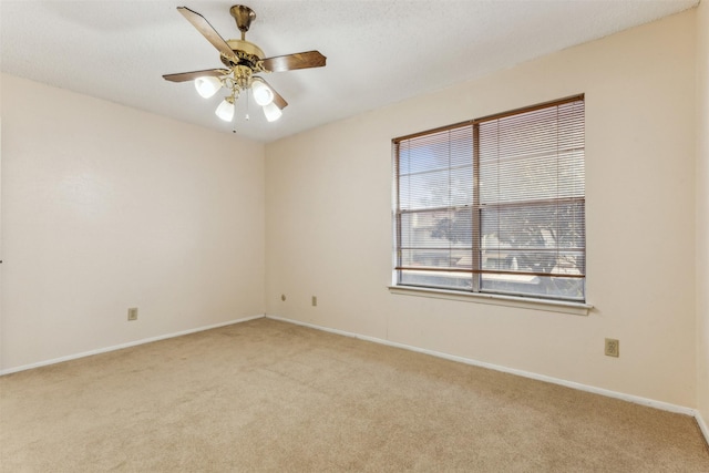 unfurnished room featuring ceiling fan and light carpet