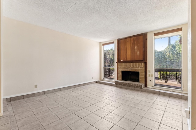 unfurnished living room with light tile patterned floors, a textured ceiling, and a fireplace