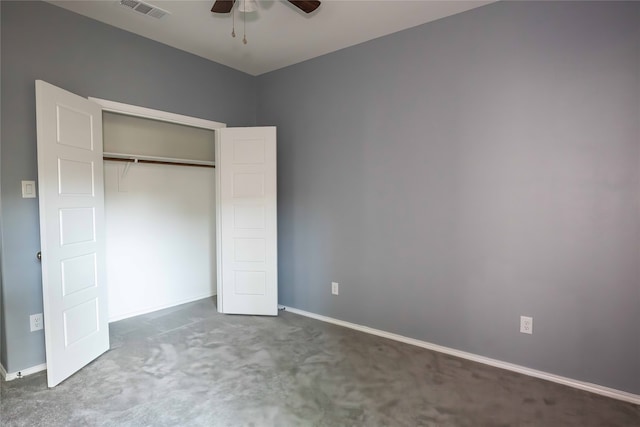 unfurnished bedroom with dark colored carpet, ceiling fan, and a closet