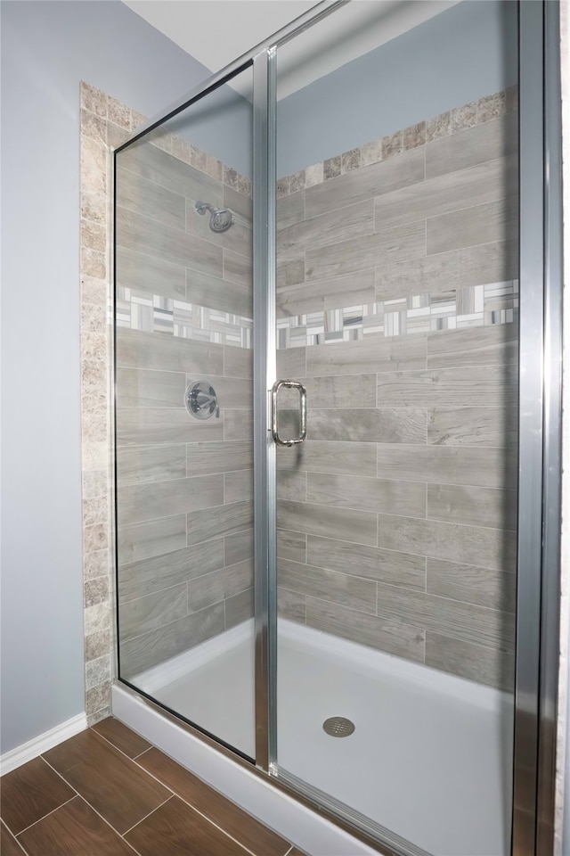 bathroom featuring a shower with shower door