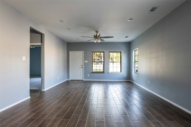 spare room featuring ceiling fan and dark wood-type flooring