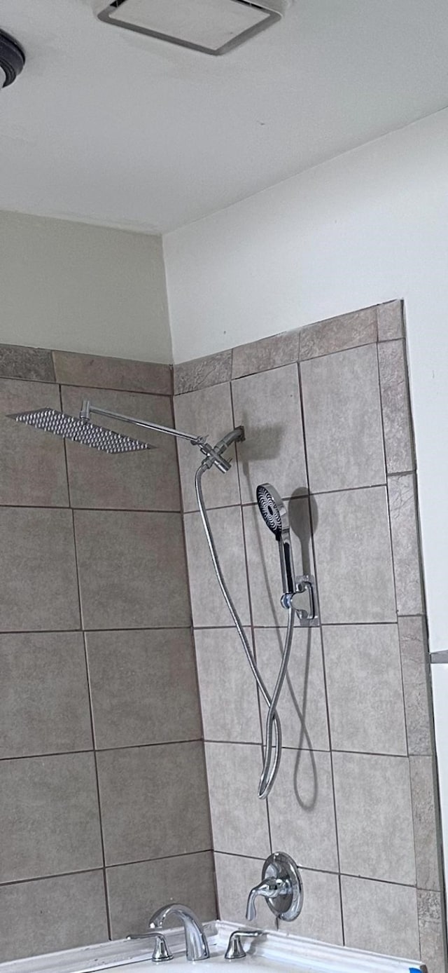 interior details featuring a tile shower