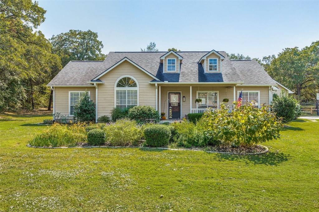 cape cod home with a porch and a front yard