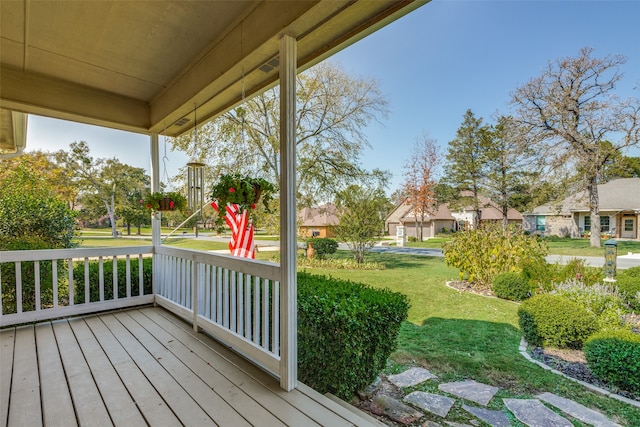 wooden terrace with a lawn